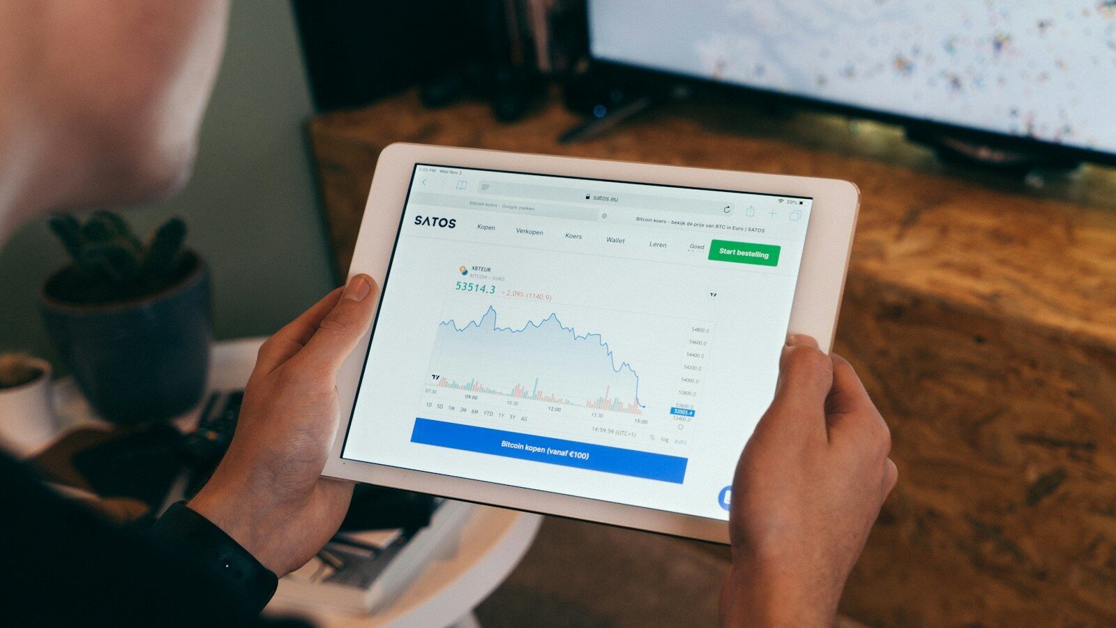 a person holding a tablet with a chart on it